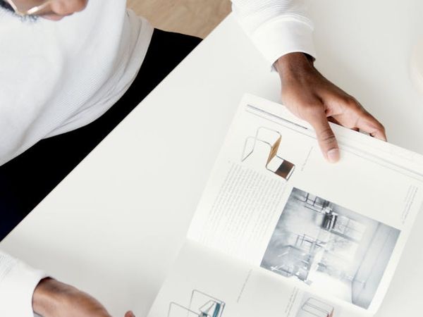 Person stretching gently at a modern, clean desk.